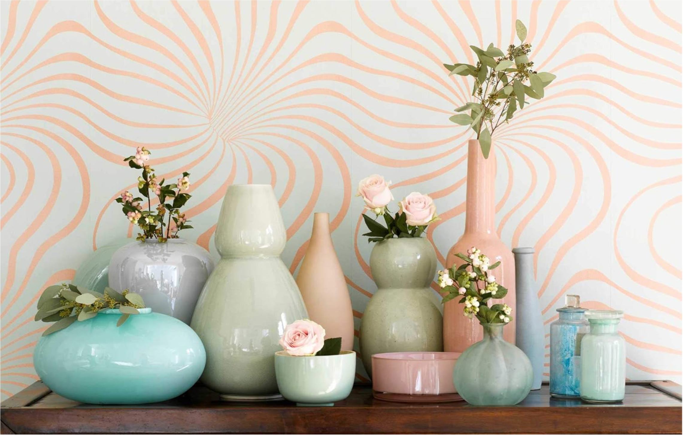 Book Jane Packer Flowers Collection of decorative vases and jars on a wooden surface with a patterned wall in the background.