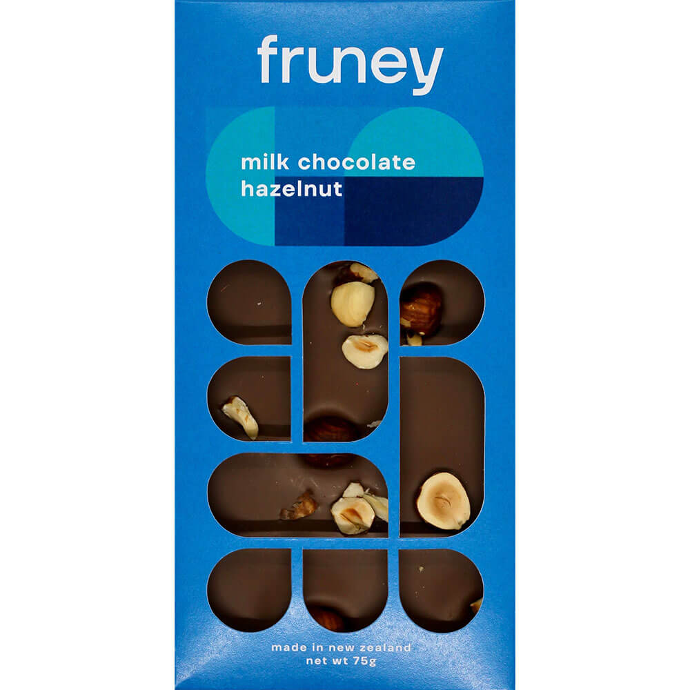 Two boxes of Ashley & Co soothe tube and Fruney dark chocolate products on a wooden surface with tulips in the background.