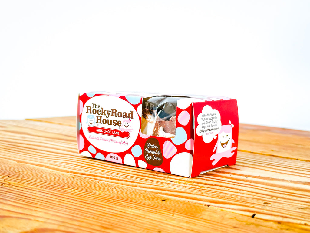 a gift box of Rocky Road chocolate bar on a wooden surface with a white background