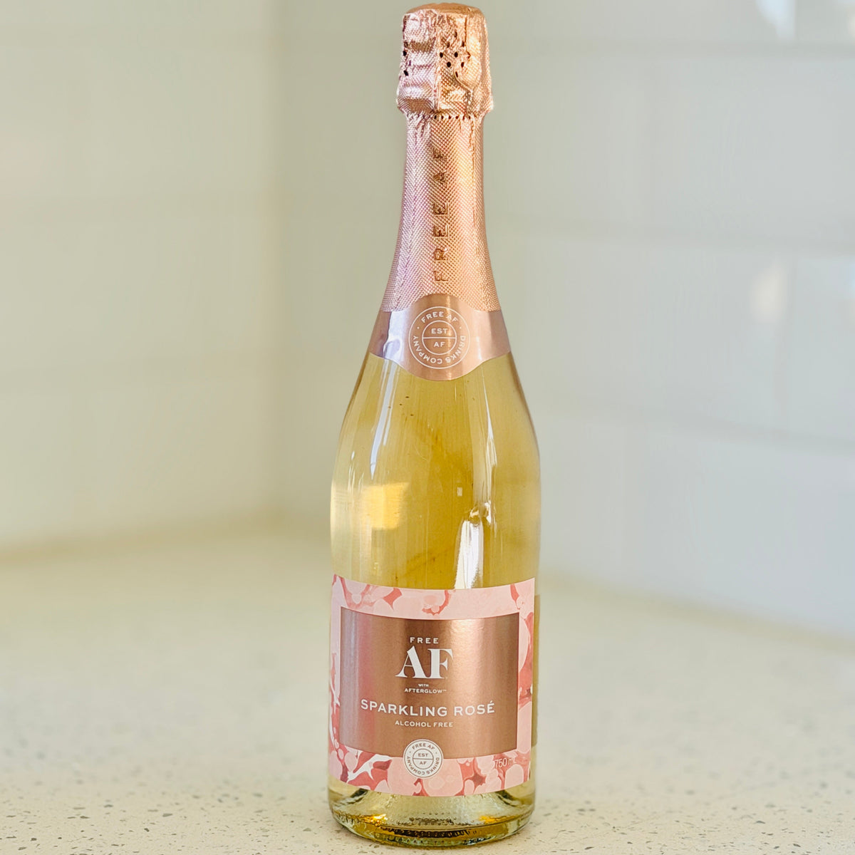 A bottle of sparkling rosé wine by The AF, f