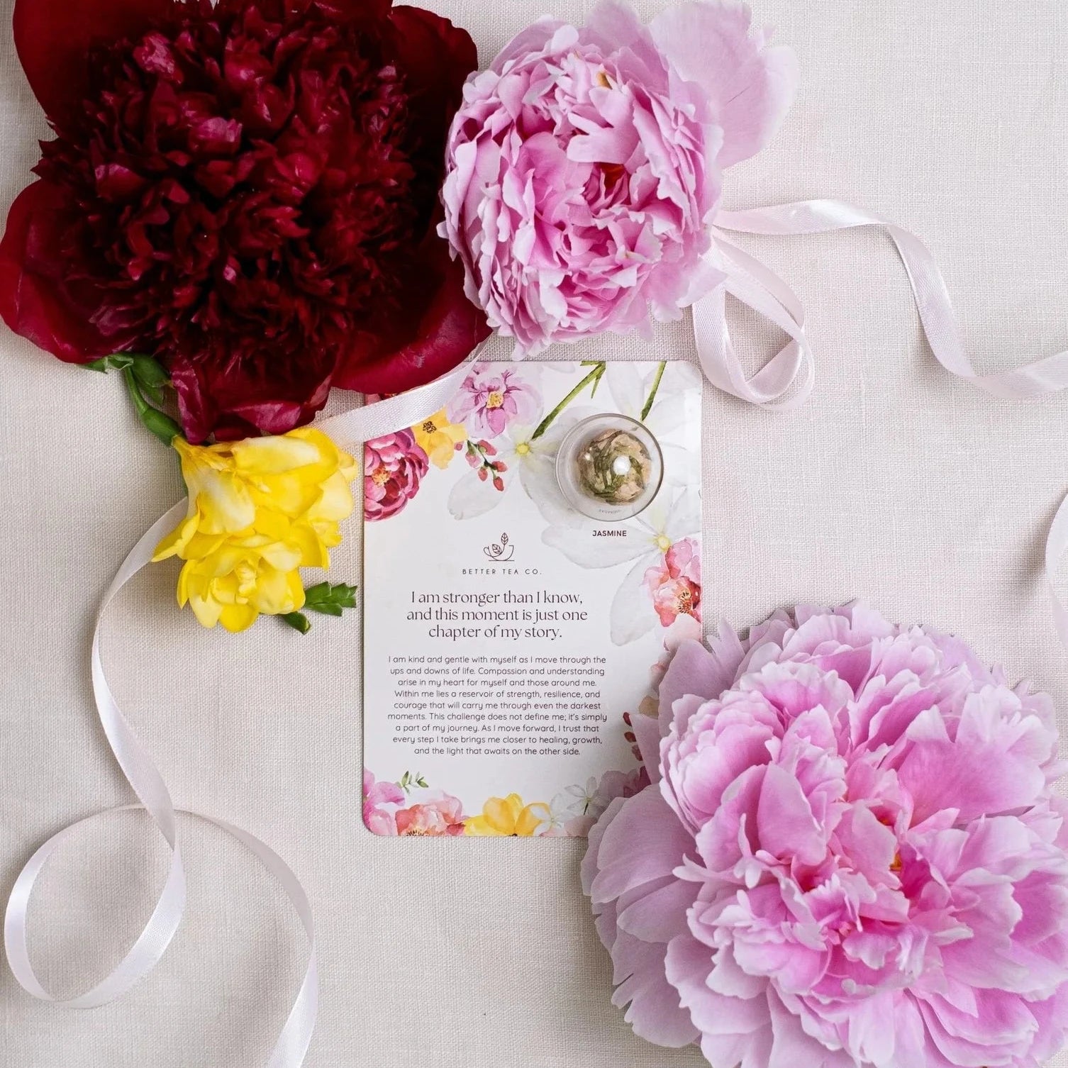 Blooming tea ball on a card with affirmation text