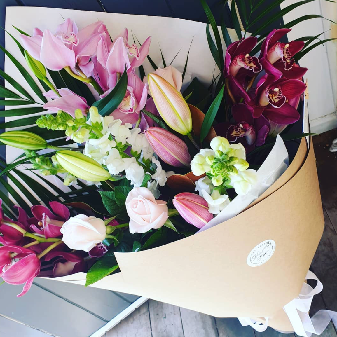 bouquet of pink orchids, roses, snap dragons