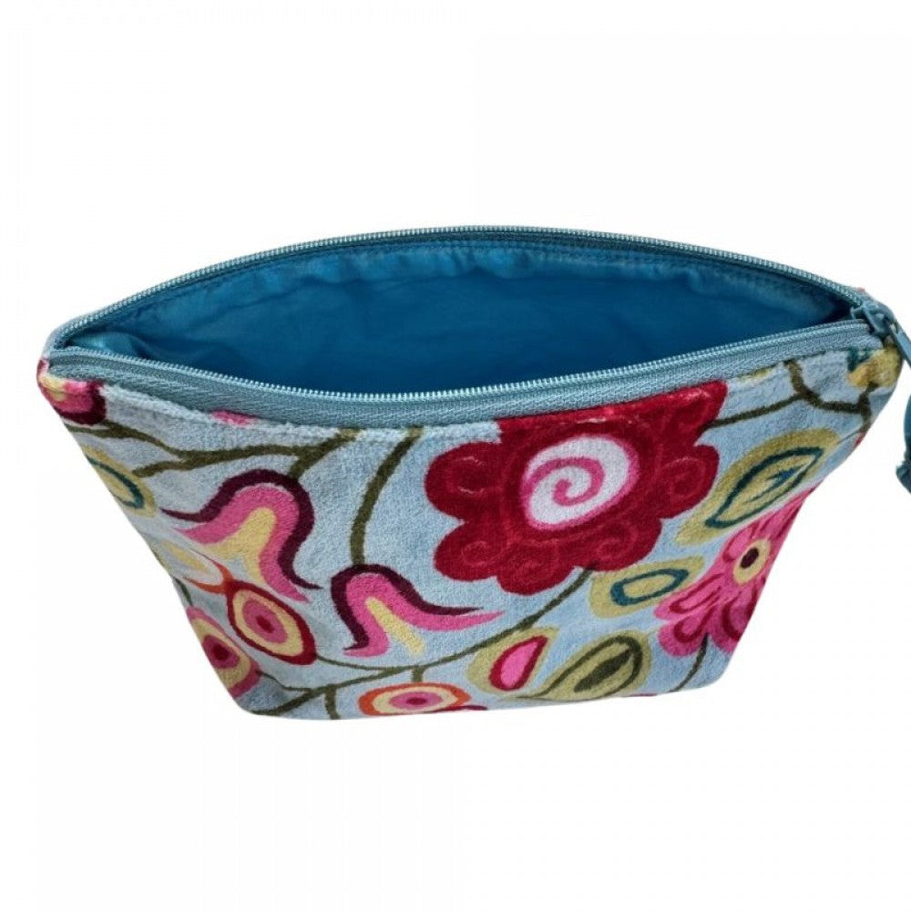 A zippered cosmetic pouch with a light blue-gray fabric base and colorful embroidered floral patterns in red, pink, yellow, and green. The interior lining is a solid bright blue, and the zipper is light blue.