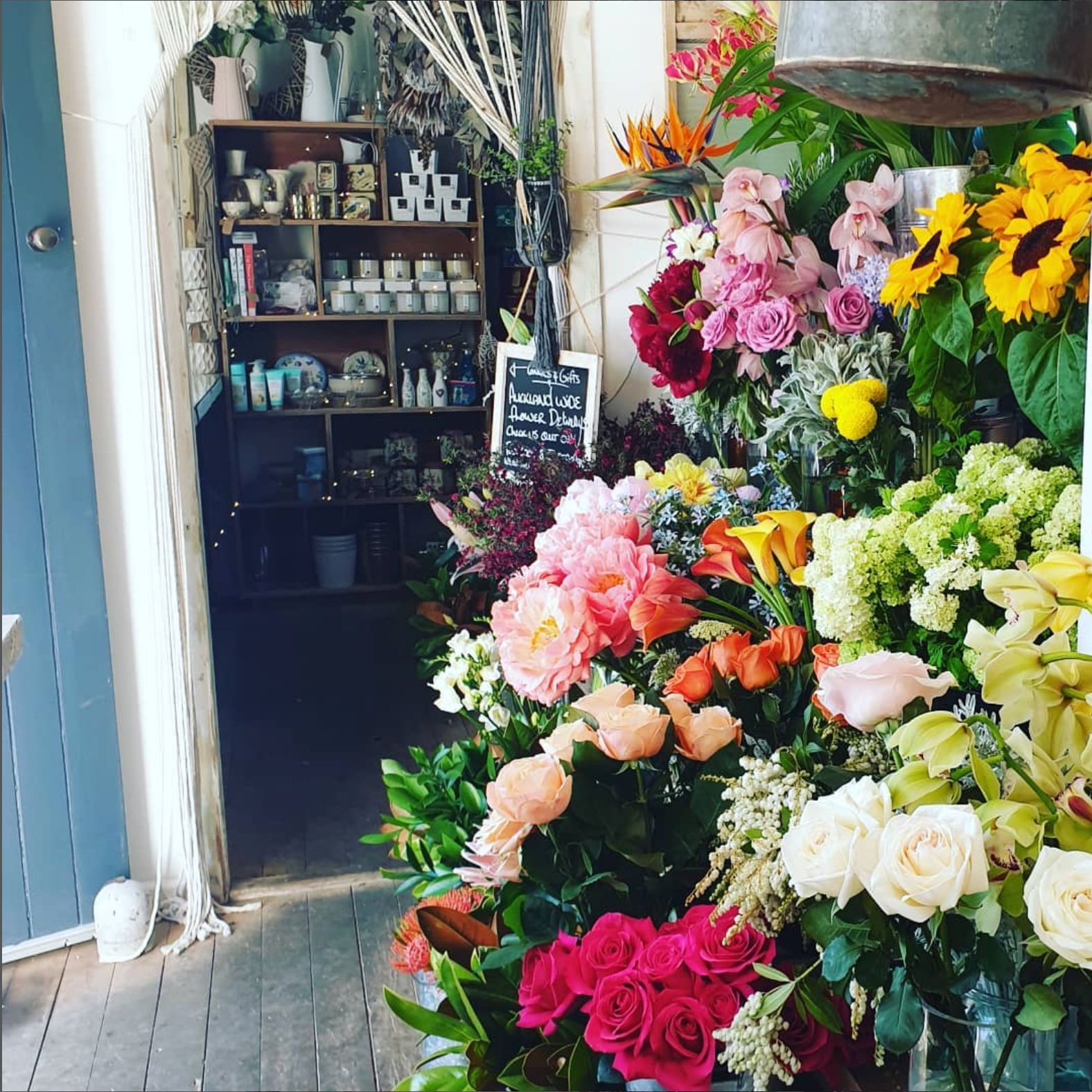 Floral arrangements in a flower shop with shelves in the background