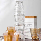 Stack of glasses that form a fish when stacked and flowers in a collection