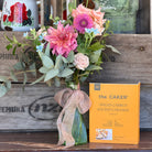small bouquet or posy with a  Caker' kit on a wooden surface.