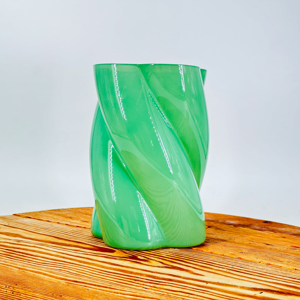 A green glass flower vase