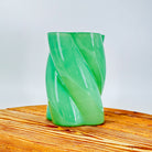 A green glass flower vase