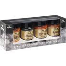 A boxed barbecue gift set containing four bottles of Ram Mountain BBQ rubs, presented in a black gift box with a clear window and smoky graphics.