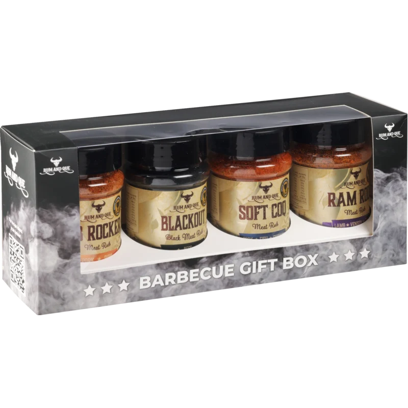 A boxed barbecue gift set containing four bottles of Ram Mountain BBQ rubs, presented in a black gift box with a clear window and smoky graphics.