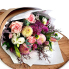 Fresh bouquet  held up infront of a wall from The Lost Flower Shed, Silverdale – same-day delivery North Shore, next-day Auckland