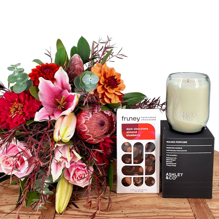 Bouquet of flowers with a bar of Fruney chocolate and an Ashley & Co scented candle
