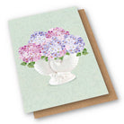Card with ceramic nautilus vase on it