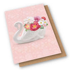 Card with a ceramic swan vase on it