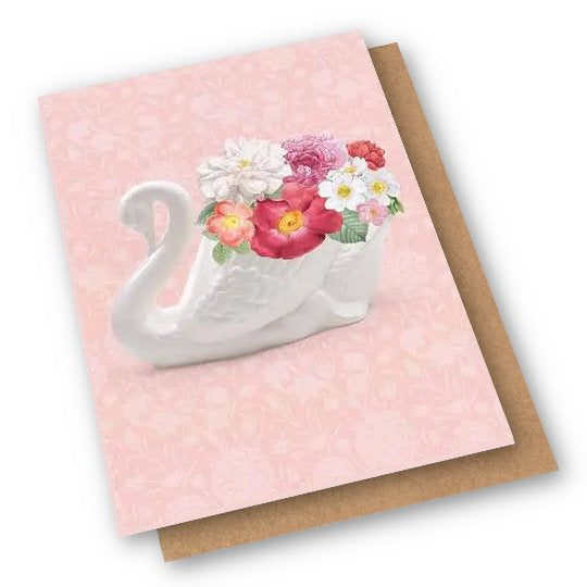 Card with a ceramic swan vase on it