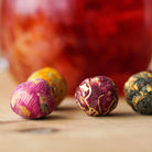 Floral packaging with blooming tea and cards on a light surface