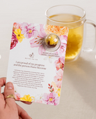 Blooming tea ball on a card with affirmation text