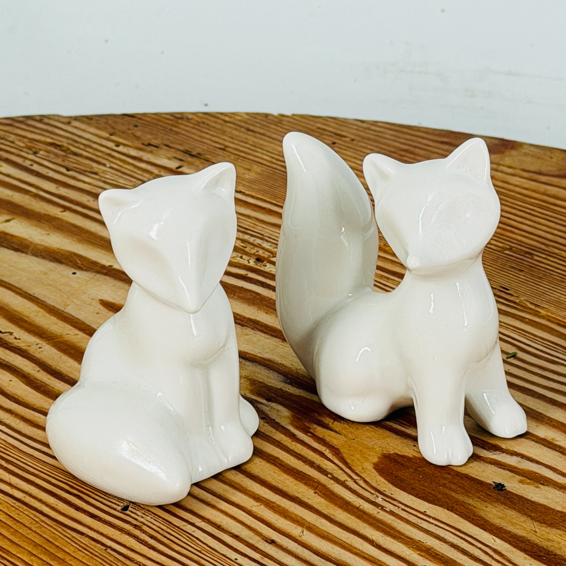 Two ceramic fox ornaments