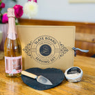 a bottle of AF Rosé, a heart-shaped slate cheese board with knife set, and a creamy Kapiti cheese, 