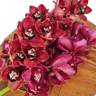 Bouquet of red orchids on a wooden  florist bench