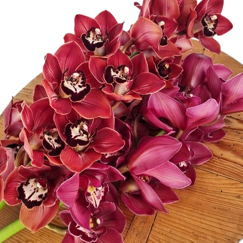 Bouquet of red orchids on a wooden  florist bench
