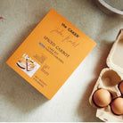 Caker cake mix box with eggs on a table