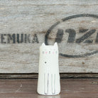 A tall cylindrical mini bud vase with floral design and text ' Life is better with you in it'.